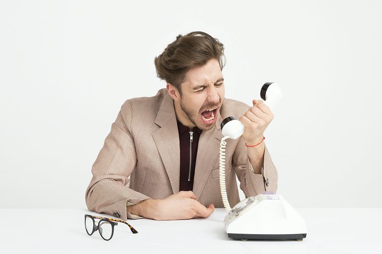 man shouting into the phone